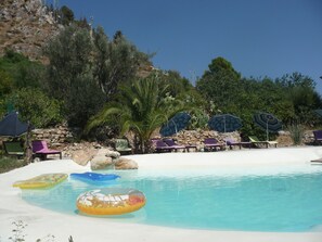 Natural lake-shaped pool in the middle of a Mediterranean garden 