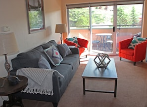 Living room: Pull-out couch & Patio w/ seating for 4