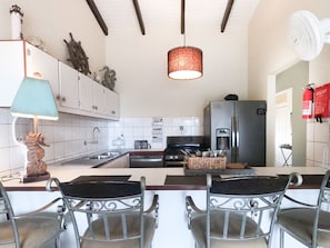 Refrigerator with water and ice dispenser, gas range and dishwasher