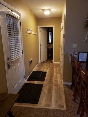 Hallway to second three piece bath