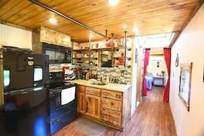 Fully equipped kitchen has everything you need to cook a meal in caboose.