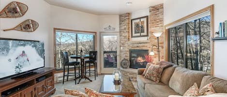 Living Room with large windows. Door to outside deck. Nice Majestic Fireplace. 