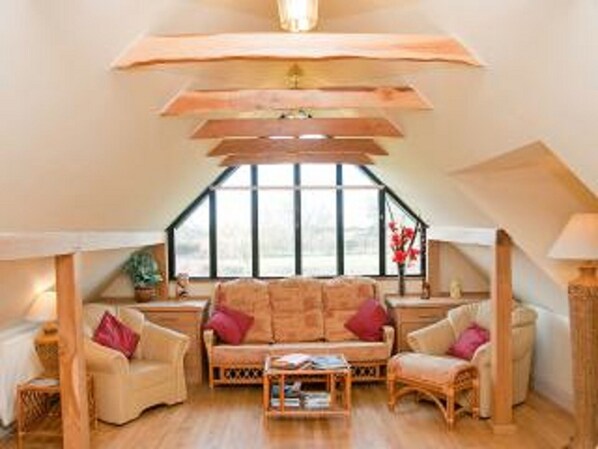 Main living area with large window over looking the garden and fields 