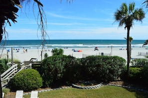 View from Balcony of Beach, Ocean, and grassy area.
