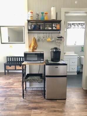 Kitchenette with microwave, mini fridge/freezer, toaster, and Keurig