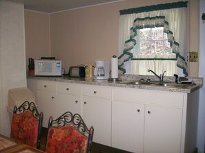 Kitchen with microwave, toaster, coffee pot and can opener