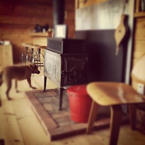 Wood stove in the living room.  Instagram #aframeflagstaff