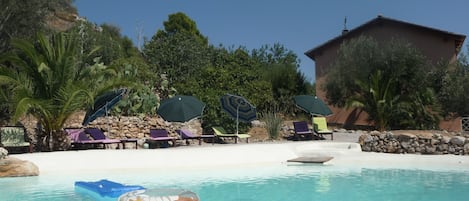 Natural lake-shaped pool in the middle of a Mediterranean garden with great view