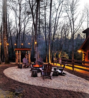 Newly redone backyard fire-pit with party lights at night