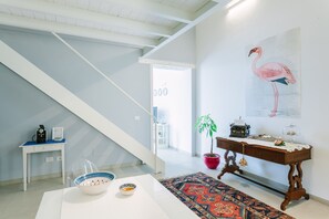 The entrance has a modern staircase leading to the bedroom with ensuite bathroom