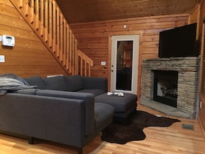 Comfy couch, fireplace and back door exit to relaxing back porch! 