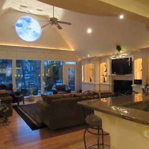 living room with lake view at dusk