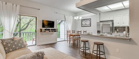 View of relaxing living room. Lots of seating w/ sleeper sofa, and loveseat, bar