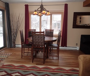 Wood dining table with leather lattice chairs seats 5