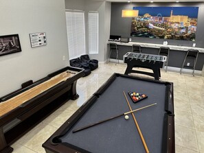 Welcome to the ultimate game room! Get ready for endless fun with a full array of entertainment options, including a pool table, shuffleboard, dart game, cards, poker chips, foosball table, and a fantastic Bluetooth speaker. There's something for everyone