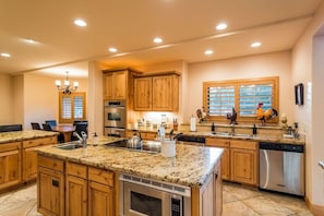 ANOTHER VIEW OF THE KITCHEN, WHICH CONTAINS EVERYTHING TO CREATE A GOURMET MEAL.