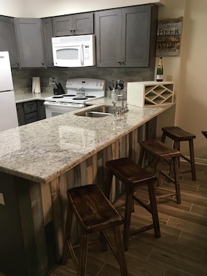 Remodeled full sized kitchen. Seating for 4 at the bar. 
New "driftwood" floors.