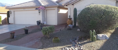 Low maintenance desert landscaping, irrigated by auto timers, walk- way lights.