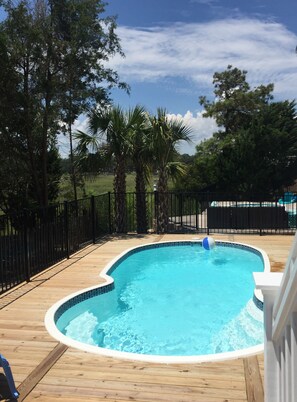 heated pool with chairs and loungers