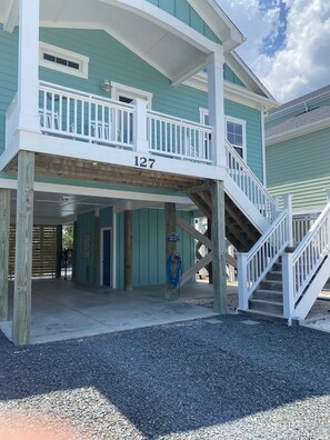 Downstairs storage area with beach chairs, bikes, pool toys, & cornhole