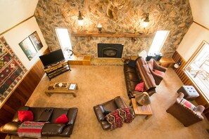 Large living room with fireplace, TV, and lots of seating!