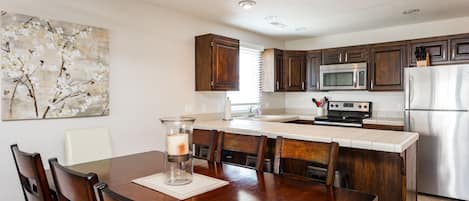 Completely new Kitchen and dining area.  Stainless appliances and bar stools.