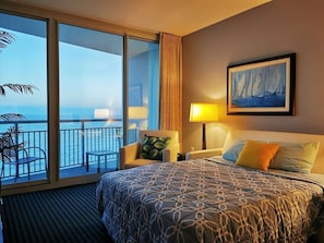 Serene bedroom with ocean views, warm lighting, and a cozy, relaxing bed.