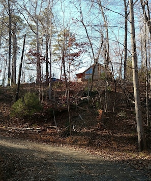 Surrounded by trees and sitting on almost an acre; short walk down to the lake