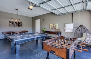 Game room with pool table, ping pong, foosball, shuffle board and game table w/seating