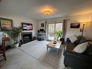 Living room with sliding doors to deck, hot tub, and mountain privacy