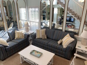 Living Room featuring brand new Sunbrella queen sleeper sofa and loveseat. 