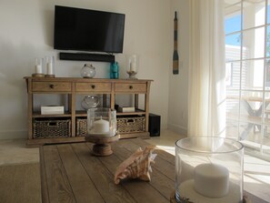 Living room Sofa view of the TV & right hand facing patio, exotic gardens & yard