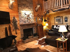 Living room has 60" flat screen , gas fireplace, heated massaging couch.
