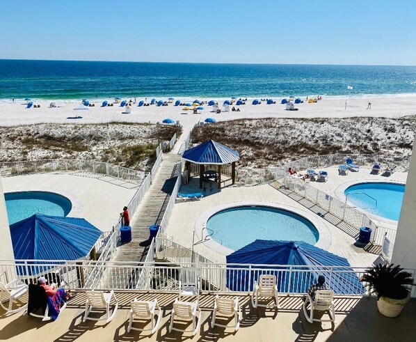 The large shared sitting area overlooks the pools, boardwalk and beach