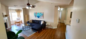 Open floor plan living room with vaulted ceilings and a fireplace.