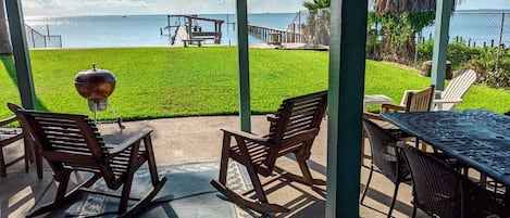 Covered patio with waterfront view. Sit down and enjoy the breeze.