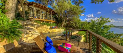 Pool/spa/decks built into the hillside banks of Lake Travis among the trees.