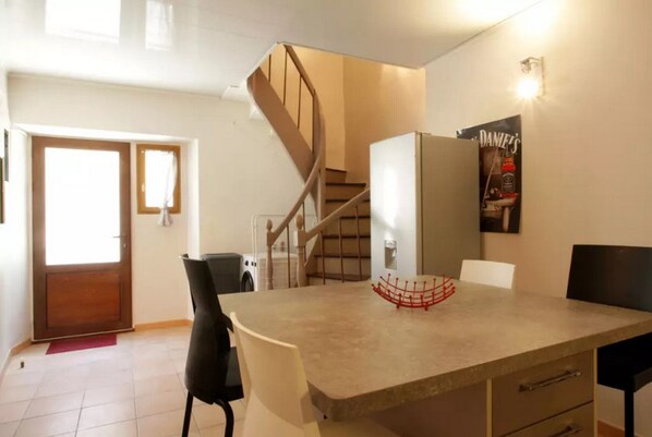 Fully-equipped kitchen and seen staircase