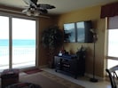 65" Sony Smart TV with Netflix adjacent to views of the gulf from living room.