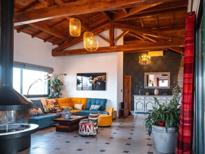 Living room with large sofa - TV screen (165cm) - Dining table for 12 people - Large central fireplace (wood provided as required)