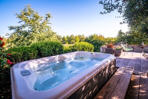 Large terrace (approx. 150m²) with 2 shaded areas and a solarium - 1 SPA integrated into the terrace, heated to 36 / 38°C, open all year round, in the shade of an olive tree. 