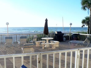 Walk out to Pool deck, table and barbecue from living room