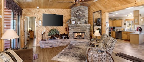 Knotty Pine Great Room with Gas Fireplace and a 65 inch flatscreen tv.