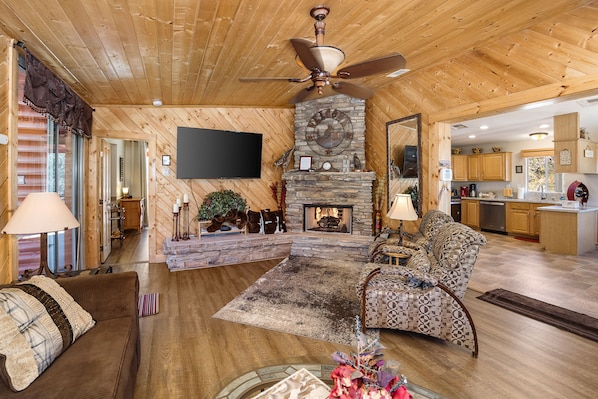 Knotty Pine Great Room with Gas Fireplace and a 65 inch flatscreen tv.