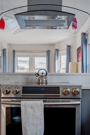 Full kitchen with stove, oven, full fridge and all the essential cookware and bakeware