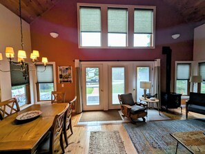 The dining and living area looking out the front windows to the deck.