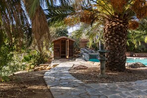 View of the Hot Redwood Sauna tucked away next to the Pool and Waterfall area.