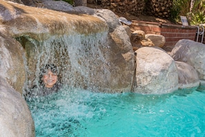 Hidden seat behind the Pool Waterfall is great fun for Kids and Adults