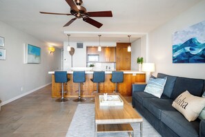 Large solid surface peninsula and 4 bar stools provide ample seating