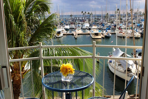 View from the quaint balcony boasting a table and two chairs. 